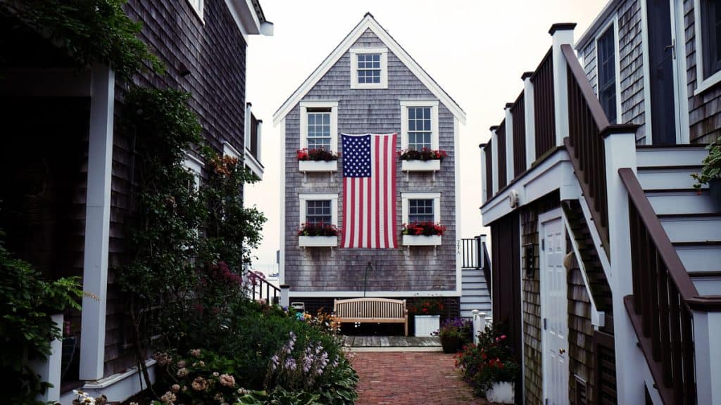 House with a large American flag hanging on the outside interior, possibly the home of a veteran with disabilities looking for small business loans.