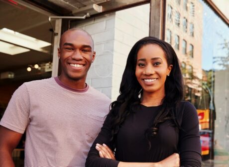 Two people smile - photo from the cover of Financial Health Network Report
