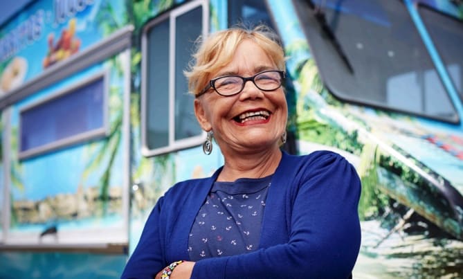 Entrepreneur smiling in front of her food truck