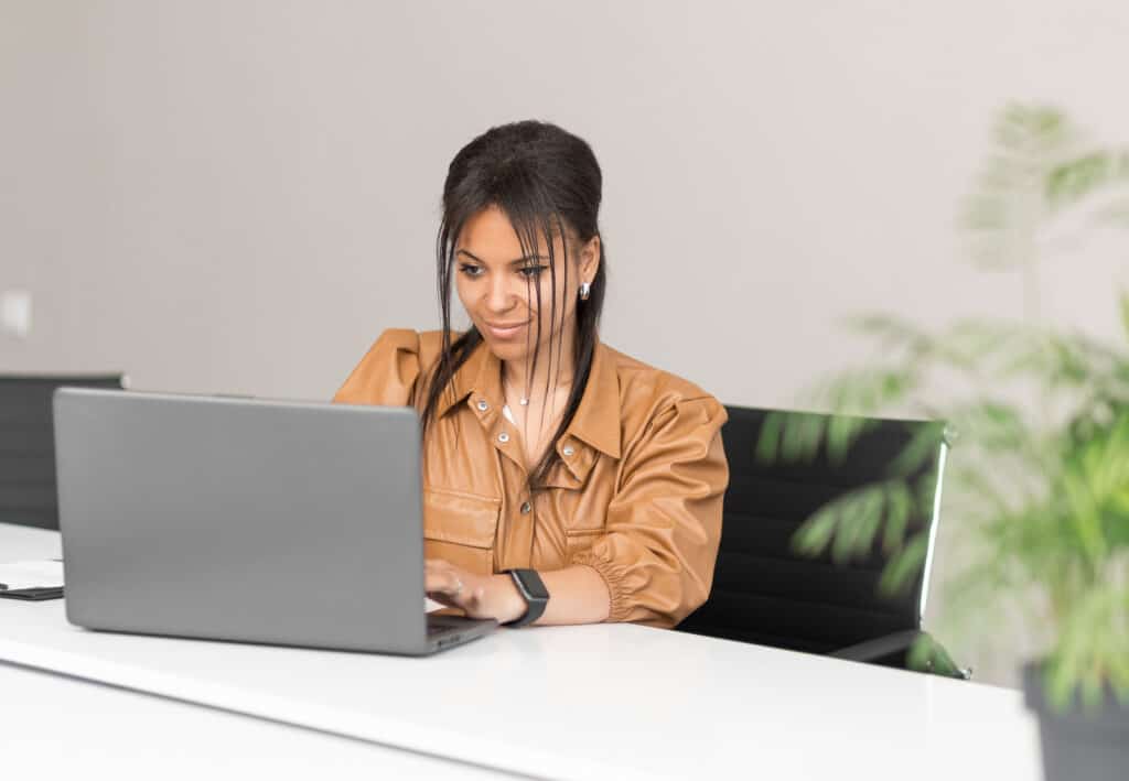 Black woman entrepreneur reviewing her business grants applications.