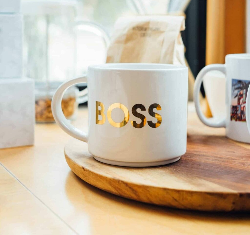 White coffee mug with BOSS written on it in gold