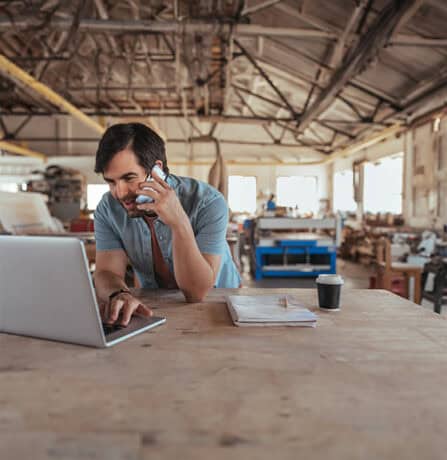 Small business owner browsing for loans at the factory