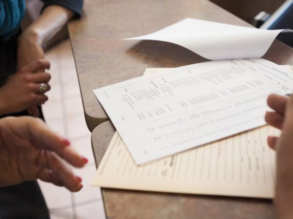 Close up of business owners' hands, who are discussing how to prepare a cash flow statement.