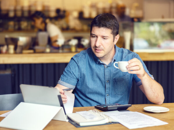 Business man calculating bills and taxes of his small business