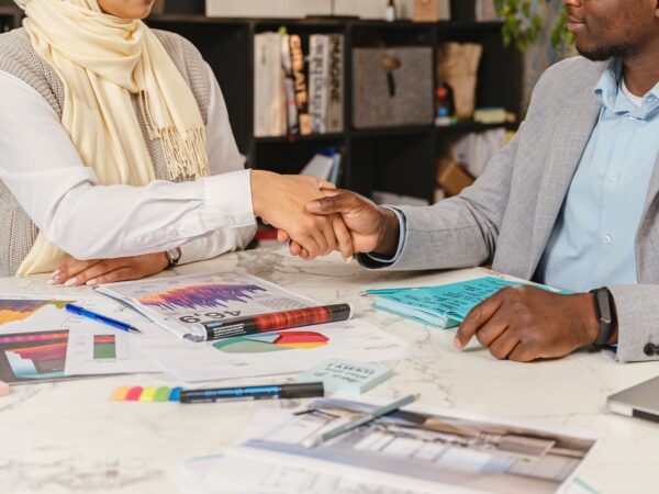 Small business partnership members shaking hands.