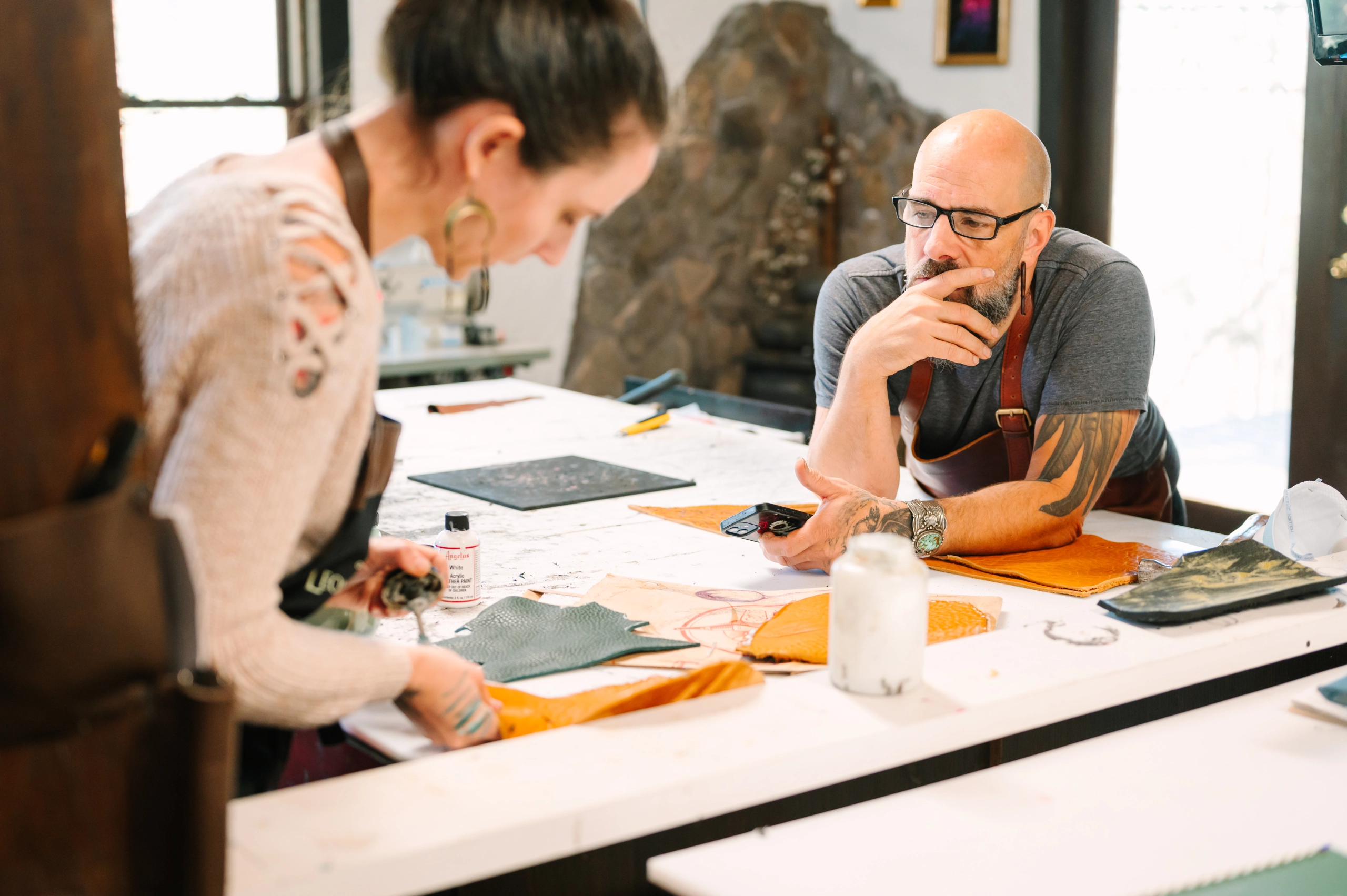 Two small business owners discussing designs